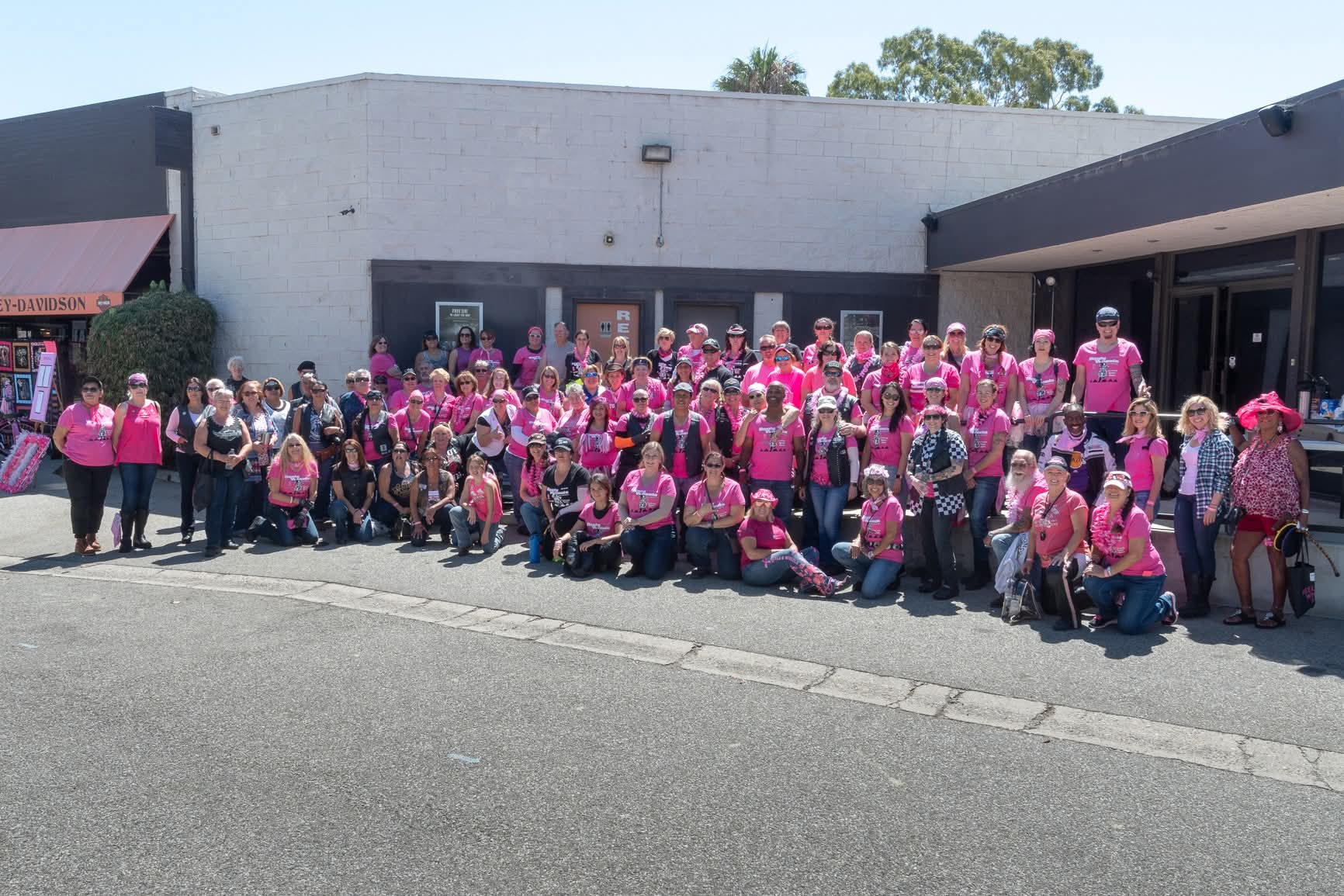 Riders in pink shirts gathered for the group photo outside Ventura Harley-Davidson